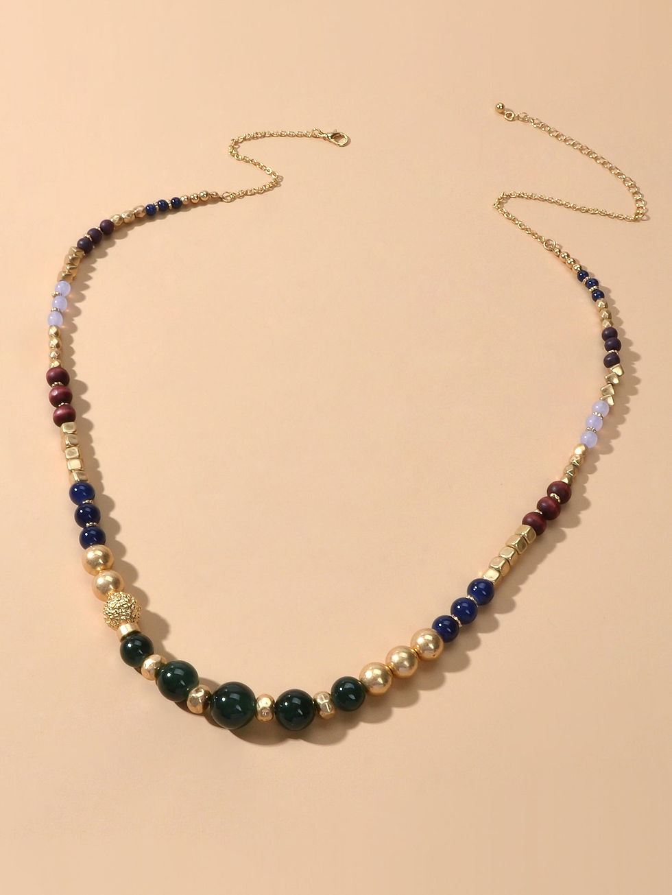 Long beaded necklace with green, blue, gold and purple beads