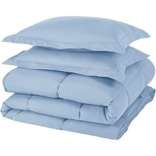 Light blue pillows and comforter stacked