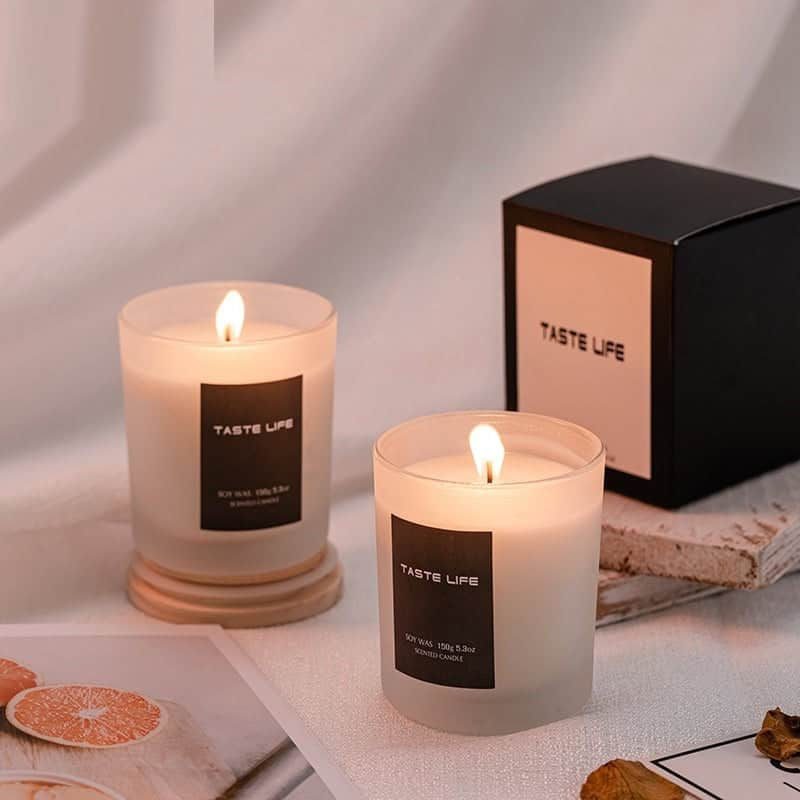 Two lit 'TASTE LIFE' candles