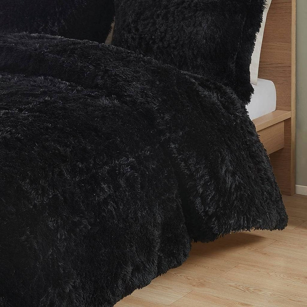 Black fluffy blanket on bed