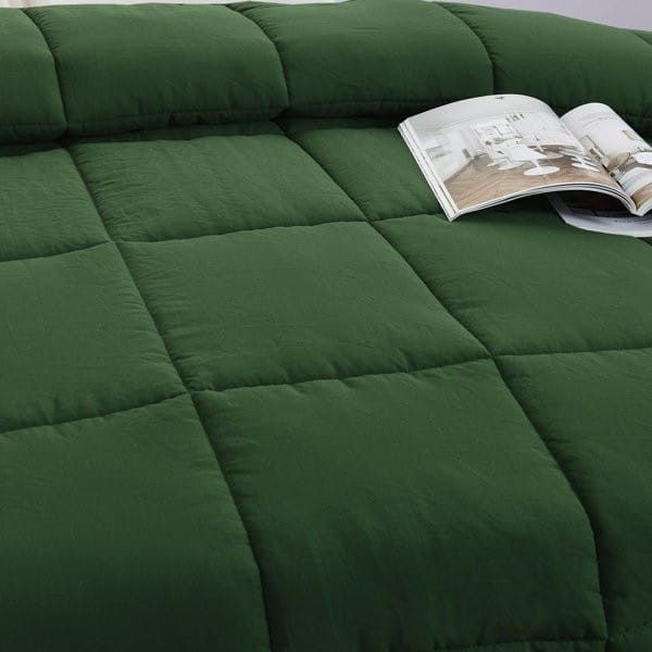 Green quilted comforter with open magazine