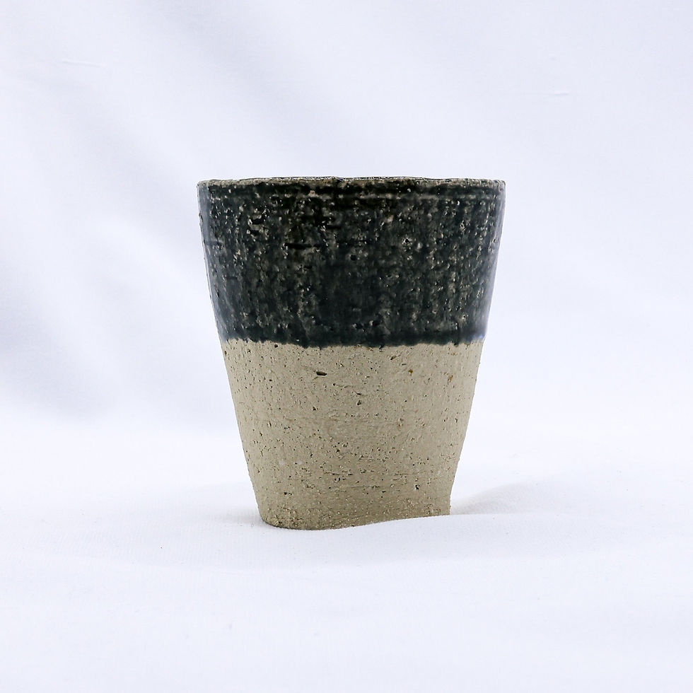 Textured black and beige ceramic cup