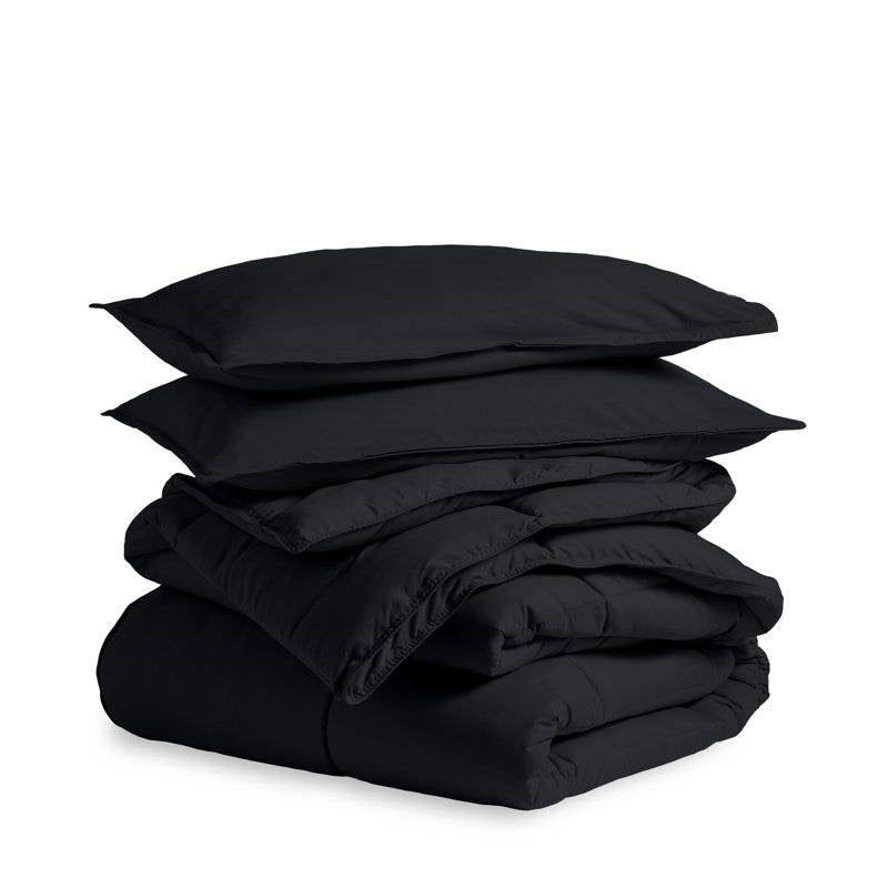Stacked black bedding set with pillows and duvet