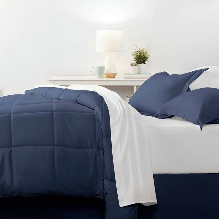 Navy blue quilted comforter set with white sheets