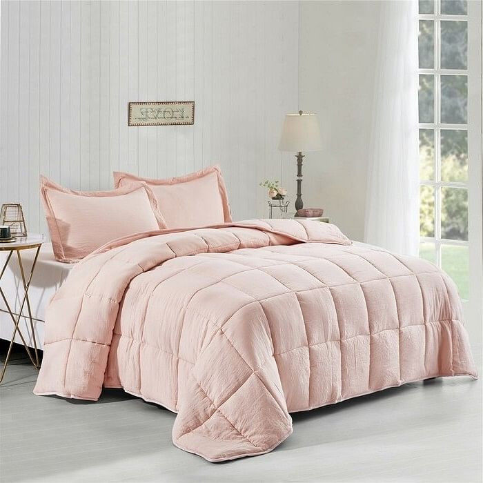 Pink quilted bedding set on bed