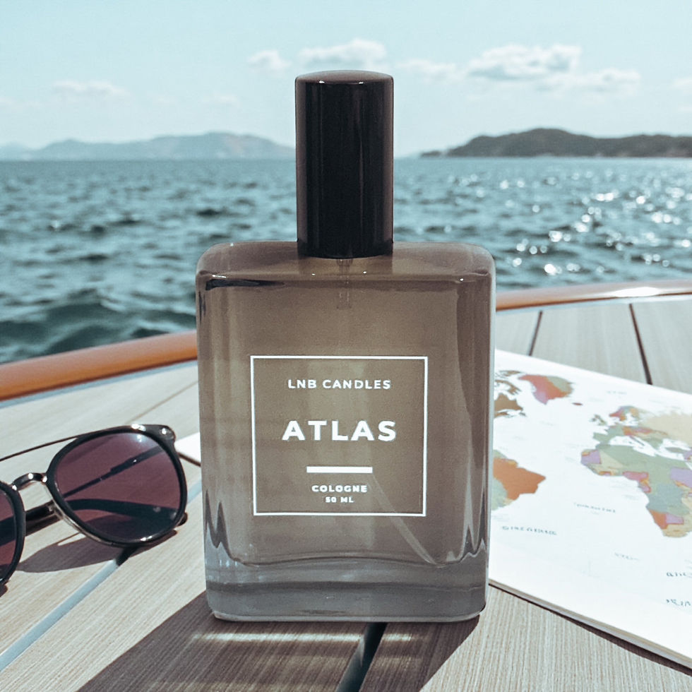 Atlas cologne bottle on a boat deck with sunglasses and map