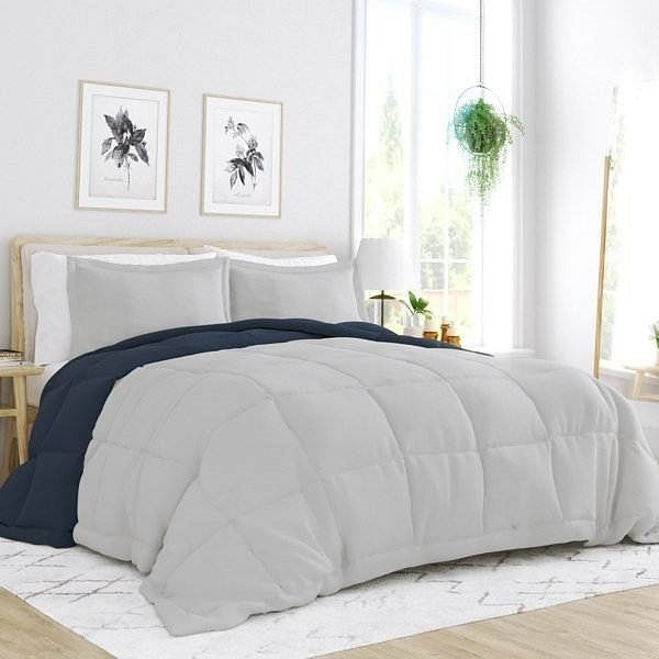 Bed with light gray and navy blue comforter