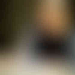 Photograph depicting Dr Claire Martin writing in a book with a smile.