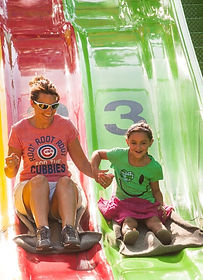Mother and child going down carnival slide