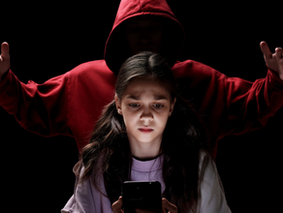 Child on phone with someone anonymous behind them