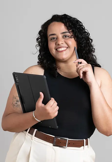 Architect Daniela Cevallos smiling while holding her tablet, conveying approachability and professionalism.