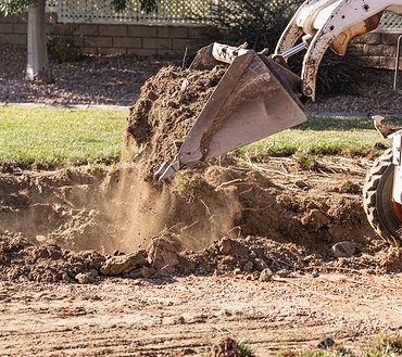 Small Bulldozer Digging In Yard For Pool Installation..jpg