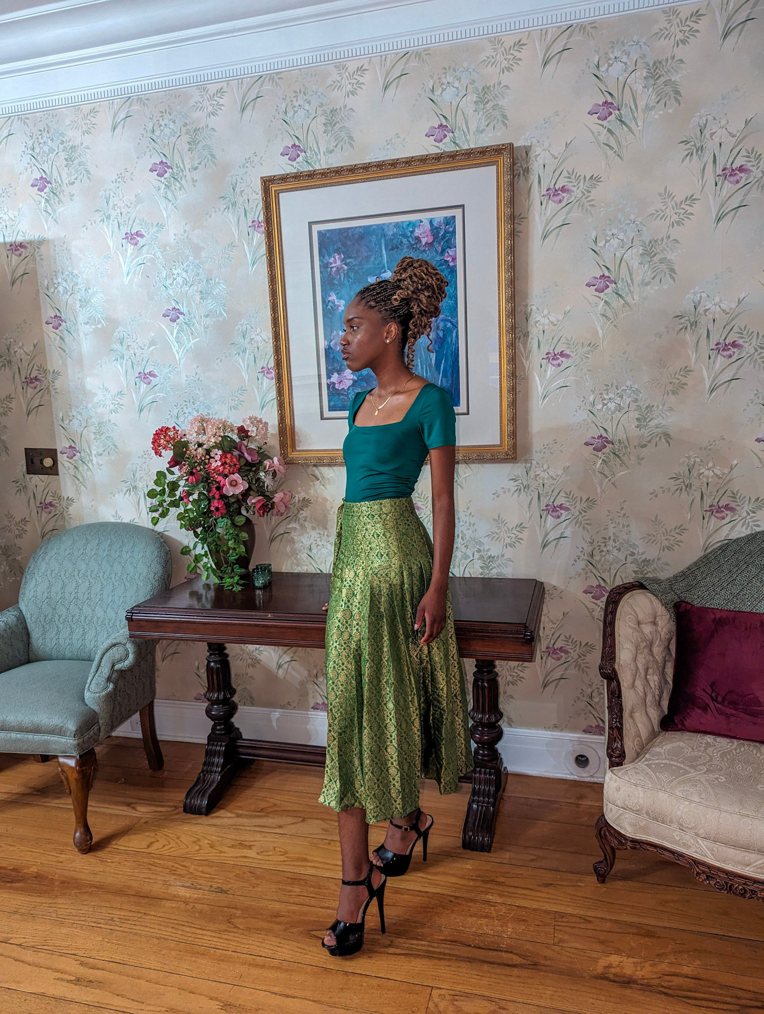 girl in green and gold pleated pencil skirt