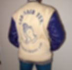 girl wearing purple and cream varsity jacket