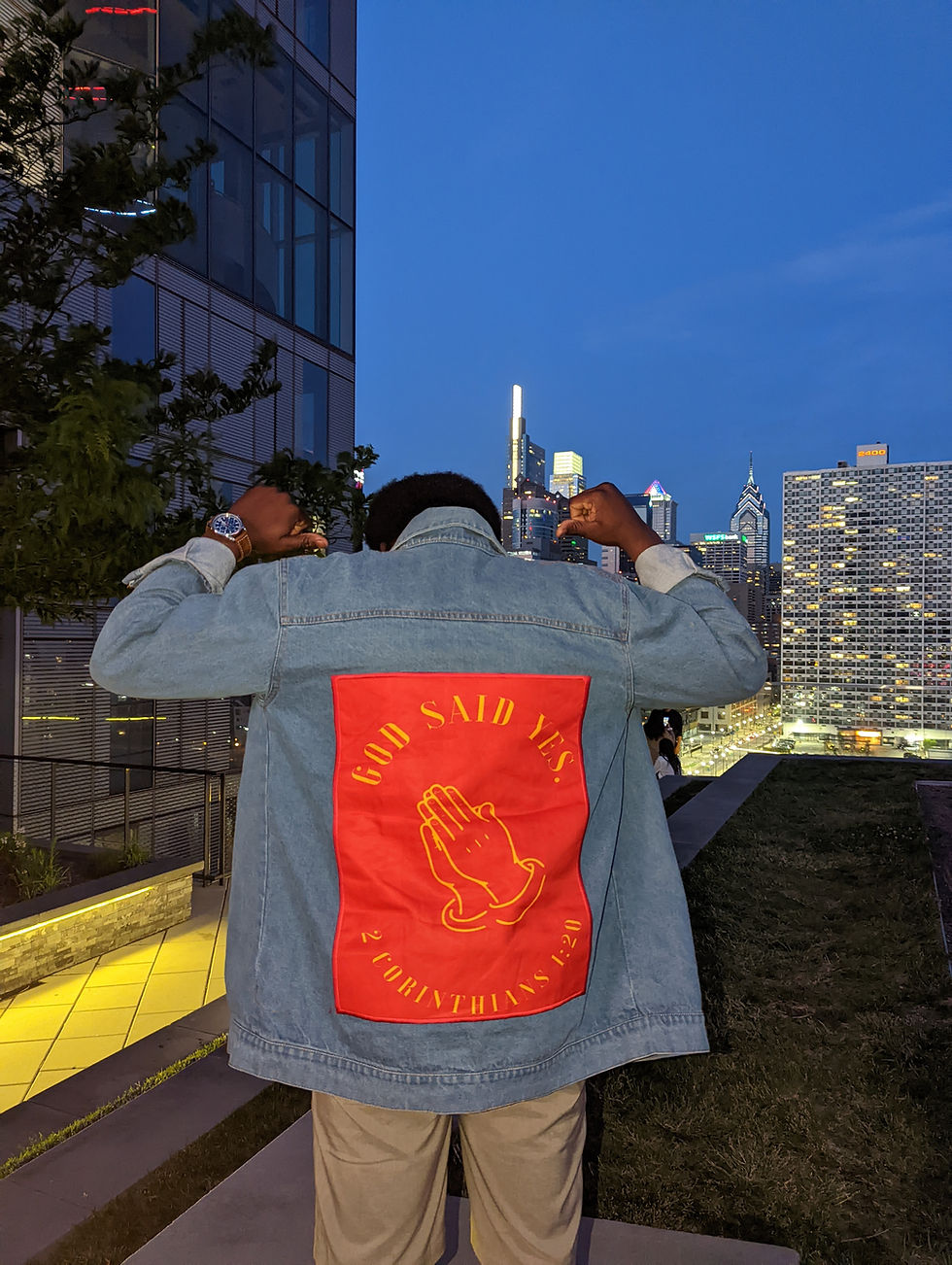 back of light wash jean jacket with bold red back that says God Said Yes in yellow