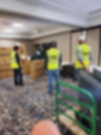 Guys unpackaging tvs in a foyer.jpg