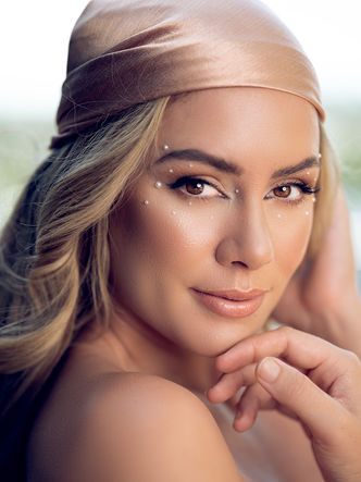 Woman in gold headscarf, subtle makeup