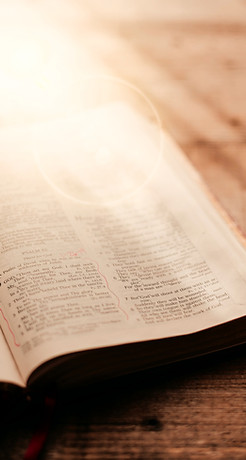 an open bible on a wooden table_edited_e