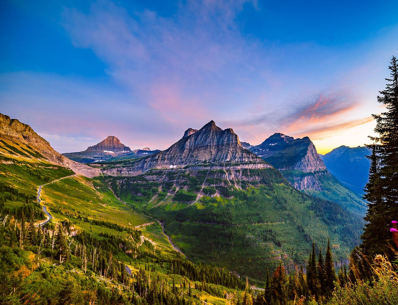 Mountain valley at sunset under a pink sky