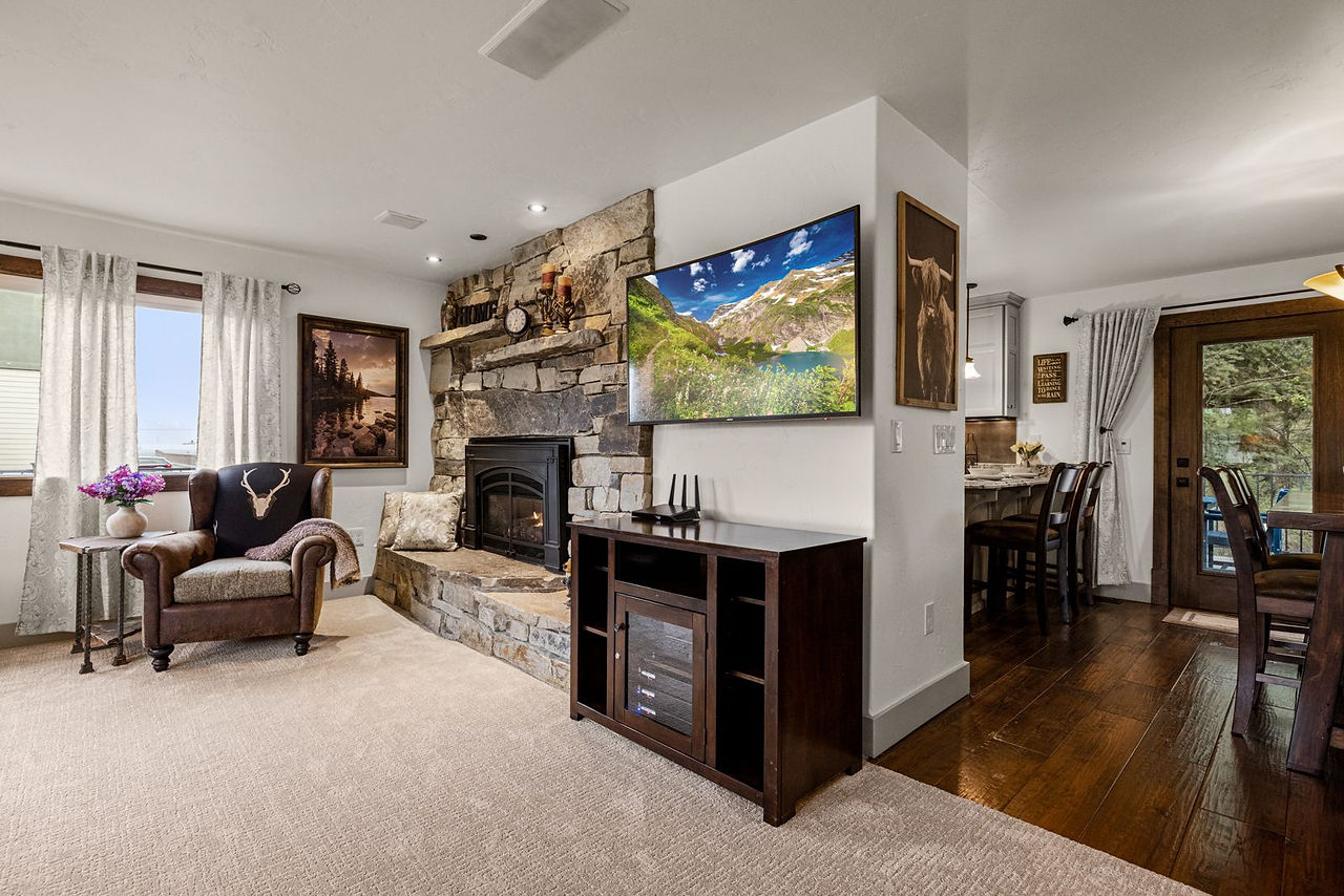 Somers House: open living room with fireplace and hardwood floors