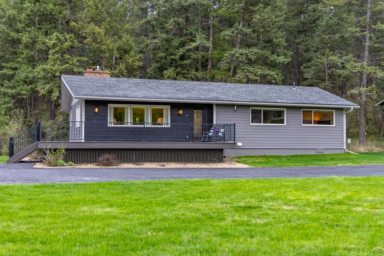 Somers House and its deck in a grassy clearing