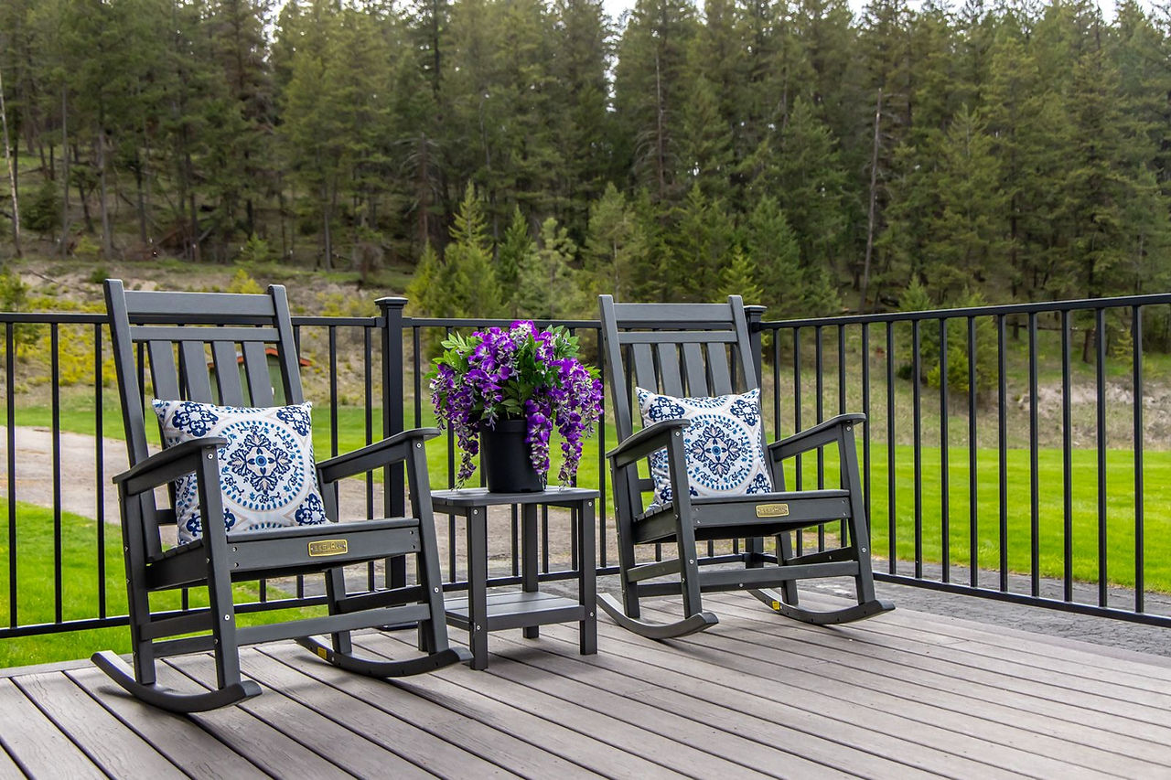 Rocking chairs and purple flowers on the Somers House deck