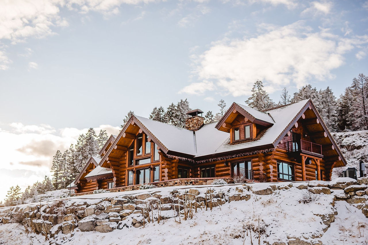 The lodge blanketed in snow in a winter forest