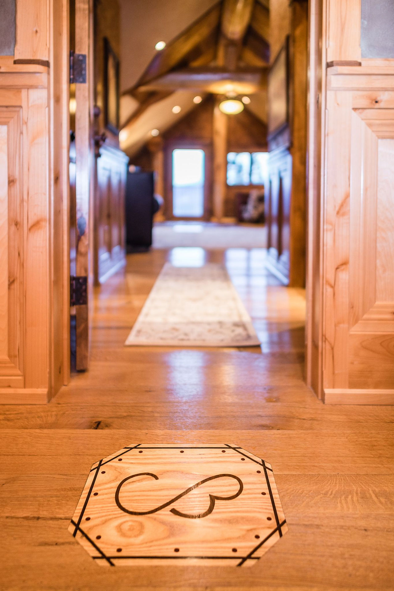 Wood hallway with the CB monogram inlaid in the floor