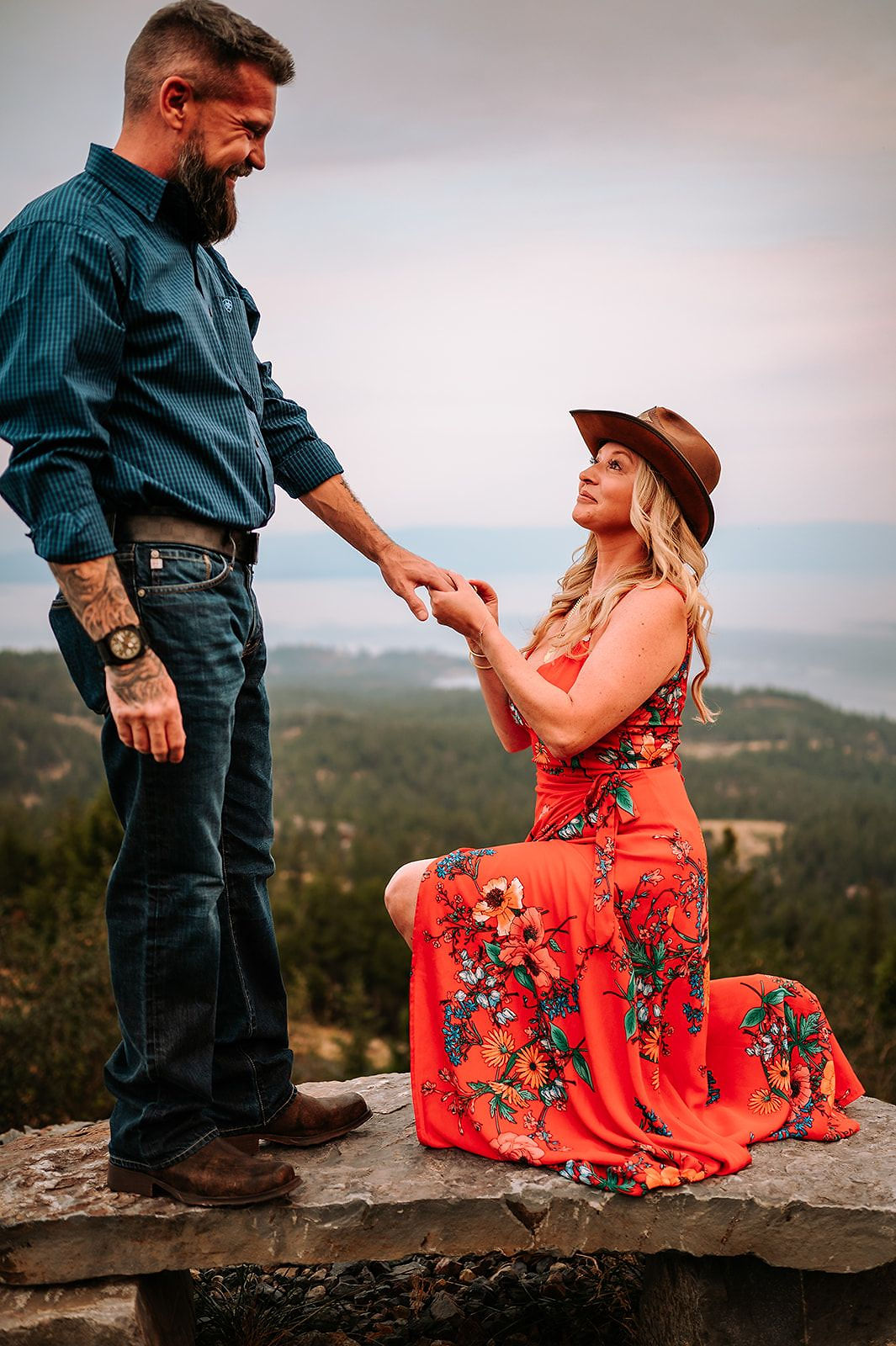 A proposal on a rocky ledge above the lake