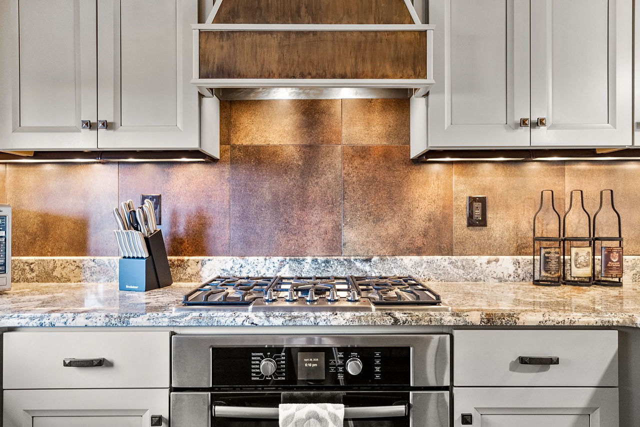 Somers House: gas range under a copper-trimmed hood