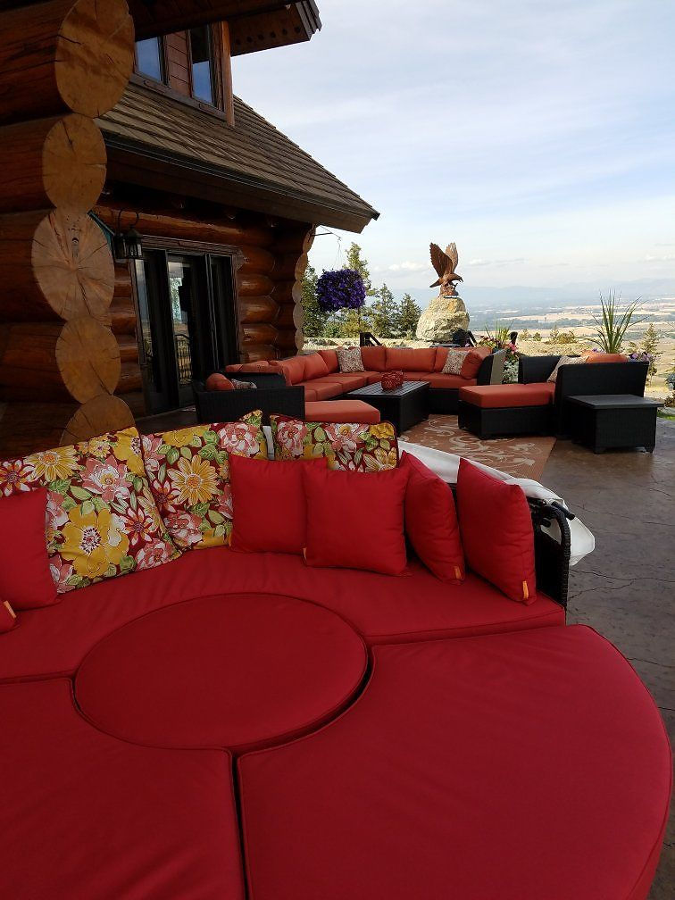Red cushioned seating on the log terrace with valley views