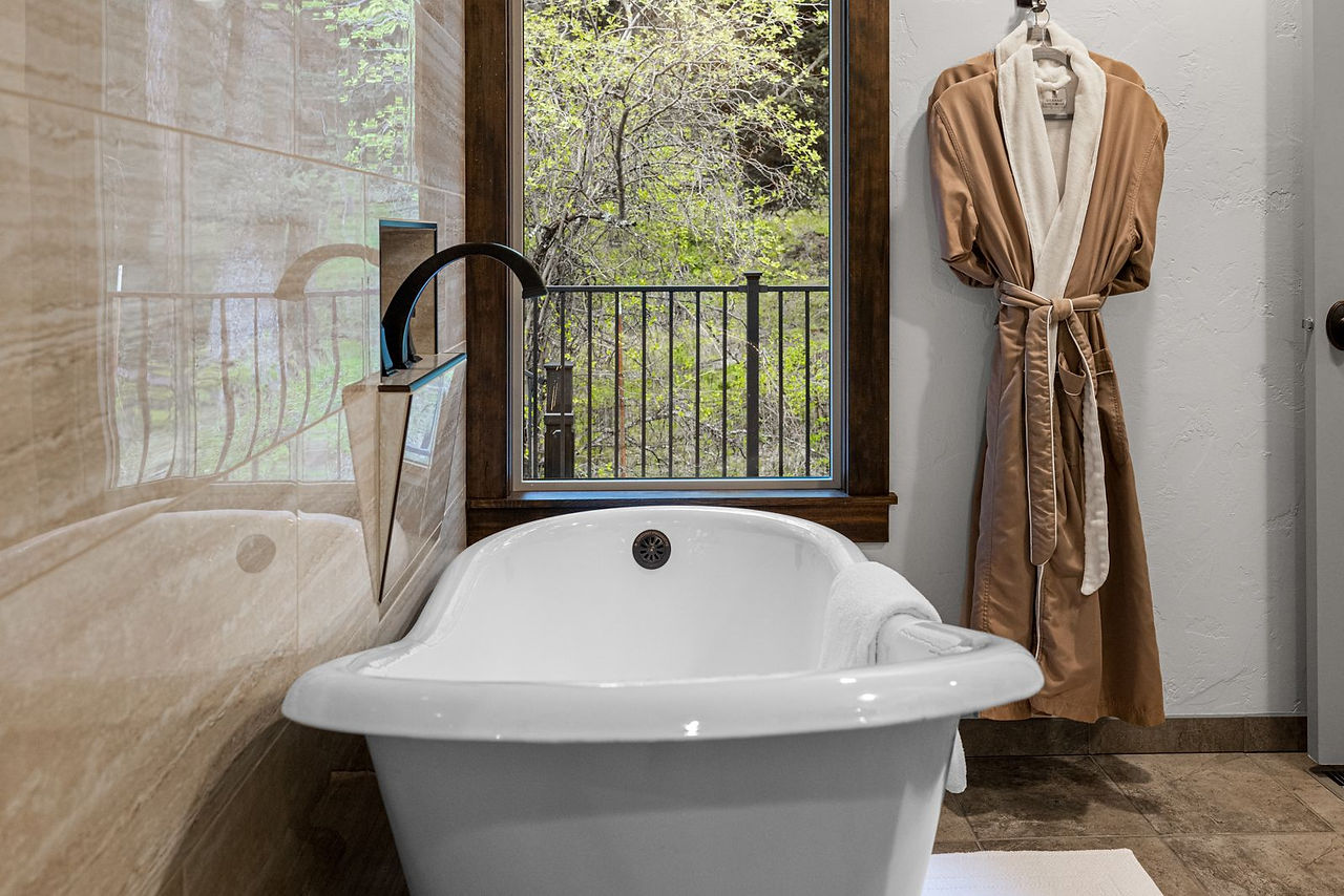 Somers House: white soaking tub and robe by the window