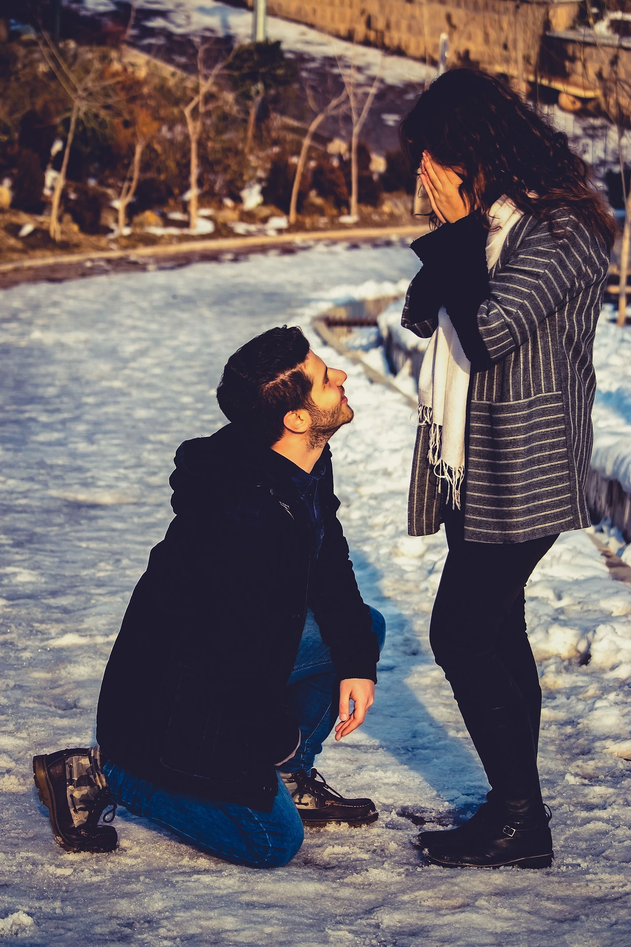 A proposal in the snow among winter trees