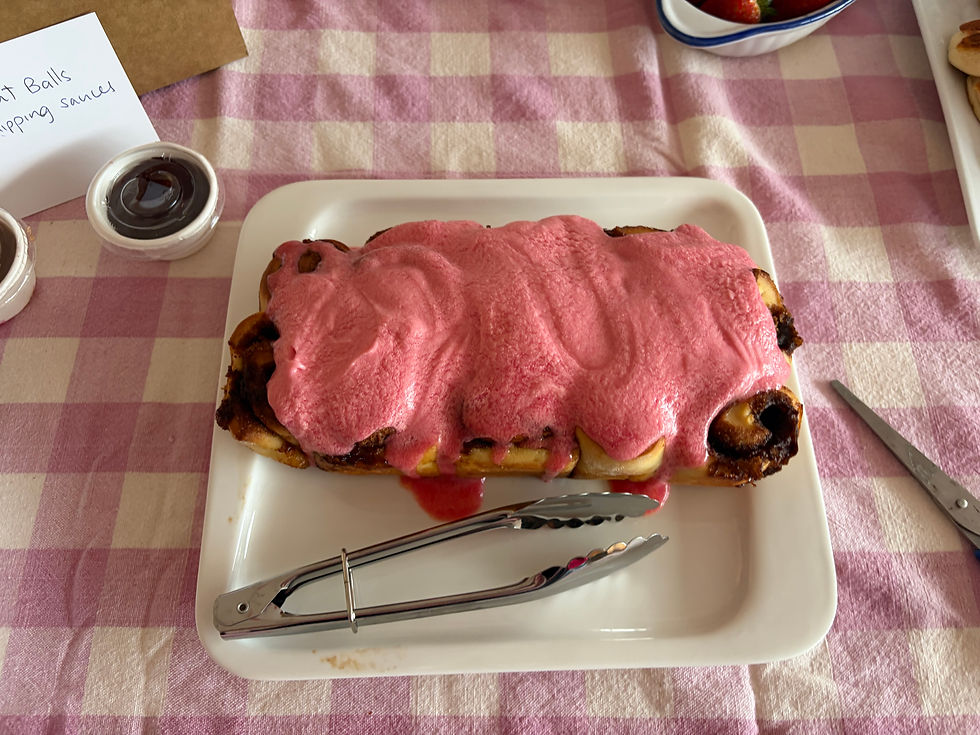 a cinnamon role loaf with pink icing