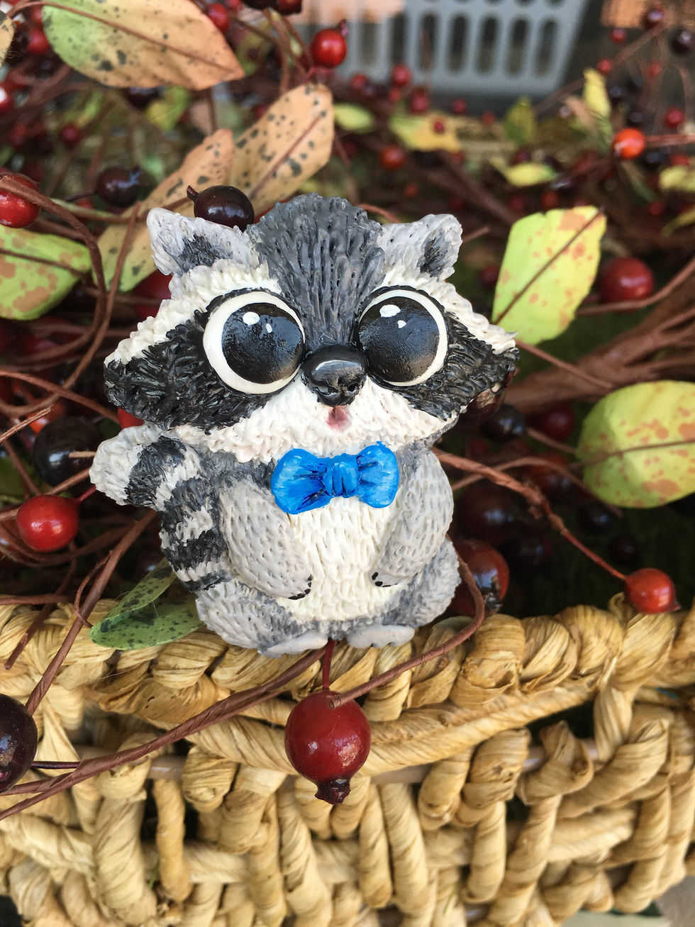 Racoon with a blue bow brooch