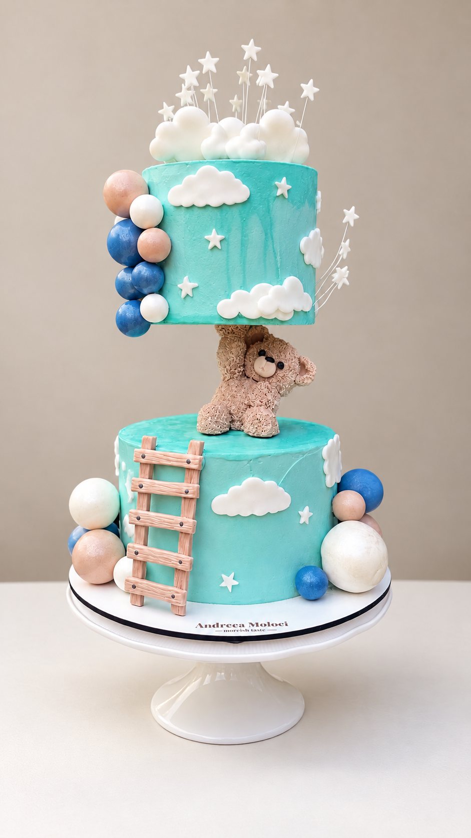Turquoise two-tier cake with teddy bear, clouds and stars