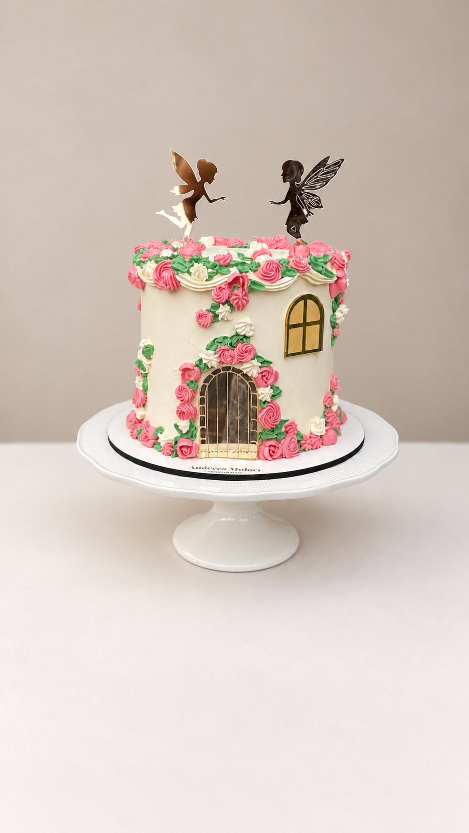 Fairy house cake with handmade piped flowers and fairy toppers