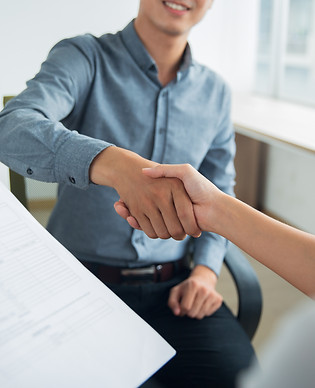 smiling-asian-businessman-shaking-partners-hand.jpg