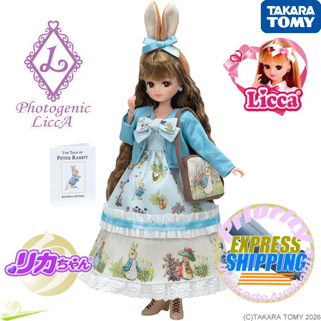 Front view of LiccA in a Peter Rabbit-inspired dress, blue jacket and rabbit-ear headband, holding a bag with one hand raised