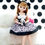 Miniatura: Front view of Licca-chan LD-07 Chao doll sitting on a white sofa, holding a mini cute panda toy on her lap with both hands.