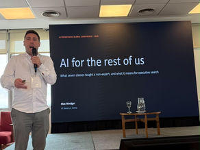 Max Woolger holding a microphone on stage at the AltoPartners Global Conference 2026, in front of a screen showing the title slide “AI for the rest of us”.