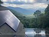 Solar panels on home overlooking mountain vista