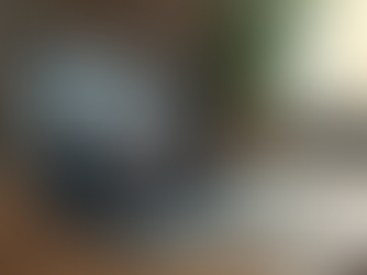 Eye-level view of a laptop on a wooden desk with a video call screen showing a couple in therapy