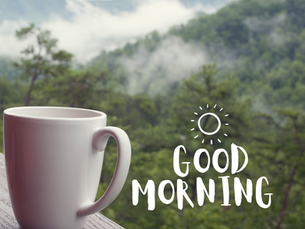 Man in white robes meditates at sunrise with glowing brain and clock symbols. Steaming cup, fruits, and open book in foreground, serene setting.