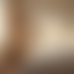 Eye-level view of a bedroom with soft lighting and a neatly made bed