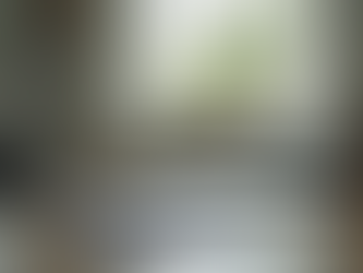 Eye-level view of a quiet room with a desk, notebook, and pen prepared for symptom tracking