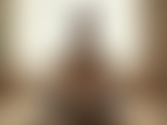 Eye-level view of a person sitting quietly in a peaceful room practicing deep breathing