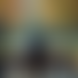 Eye-level view of a person sitting alone on a park bench looking away thoughtfully