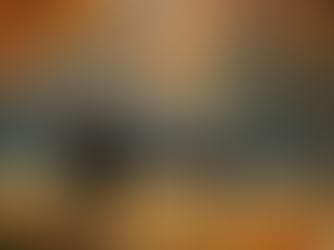 Eye-level view of a solitary figure sitting on a park bench surrounded by autumn leaves