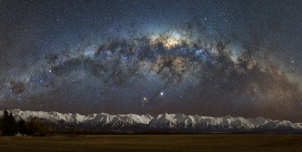 Stars of the Milky Way above the snowy mountain ranges of New Zealand's Southern Alps
